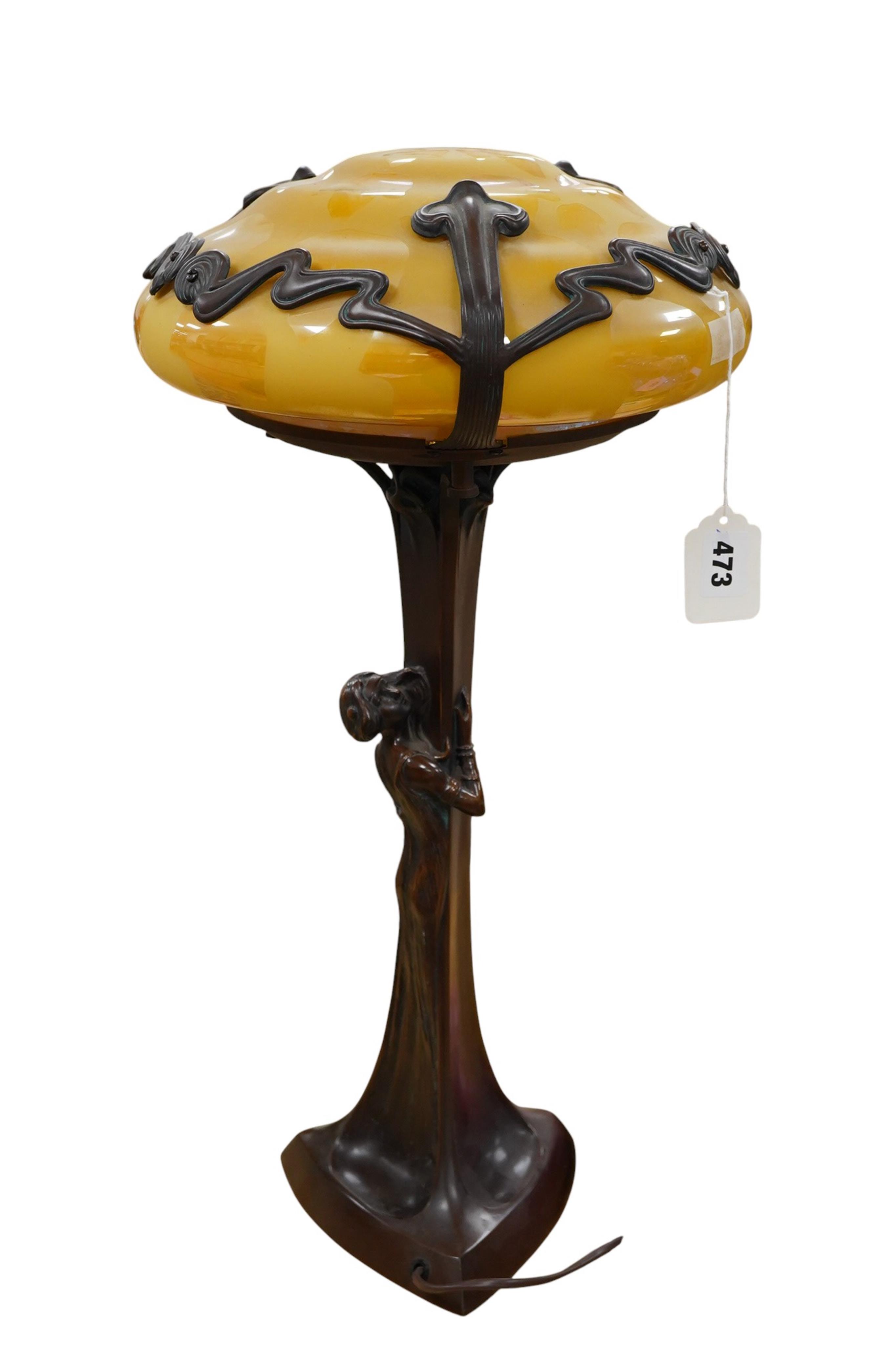 In the manner of Gustav Gurschner, an Art Nouveau style figural bronze lamp with yellow etched shade, 58cm
